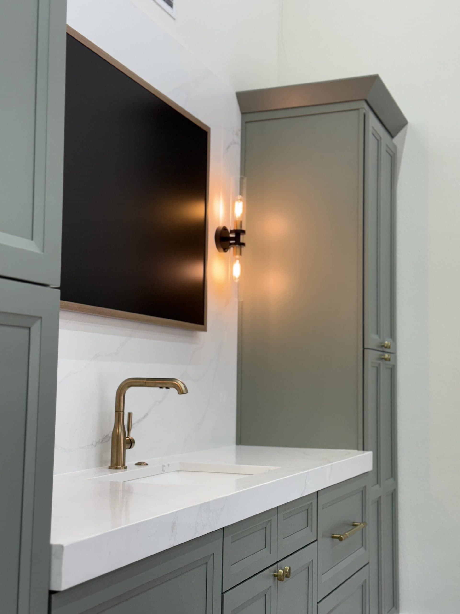 Sage green vanity with brass fixtures — Safety Harbor, FL